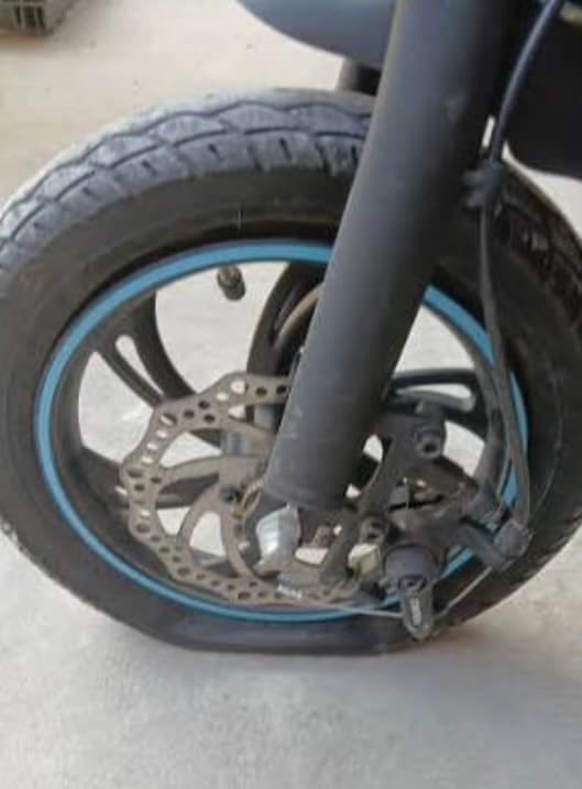 A real electric scooter tire sitting flat against the ground